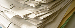 pile of papers held with paper clips